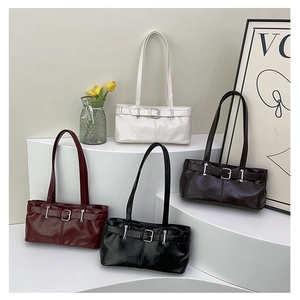 Detail of four glossy faux leather tote bags in burgundy, cream, black, and brown colors