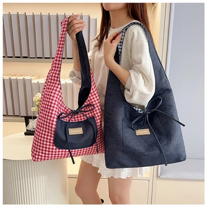 Detail of checkered tote bag and denim tote bag with bow decoration and leather fashion tag