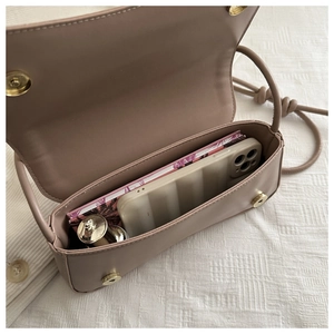 Internal view of mocha handbag showing storage for phone and small daily essentials