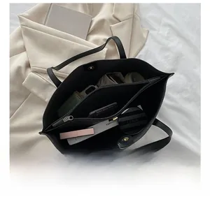 Detail view of large capacity black leather tote bag with functional inner compartments