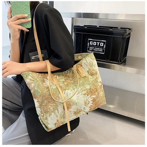 Close-up of floral jacquard tote bag featuring light brown leather straps on a model
