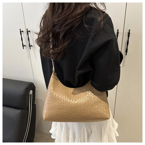 Chic PU woven underarm bag in khaki, shown carried by a model in a minimalist setting