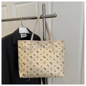 Detail of off-white tote bag with bear patterns on a minimalist hanger setting