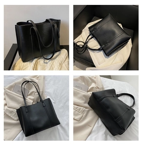Detail view of black pebble leather tote bag featuring a spacious trapezoid design and shoulder straps