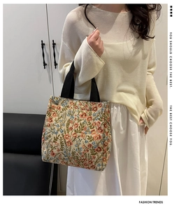 Detail view of large capacity floral tote bag with vintage patterns and black handles