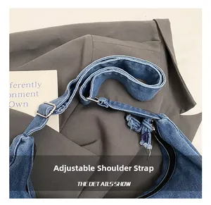 Detail of adjustable denim strap with silver buckle and premium stitching on messenger bag