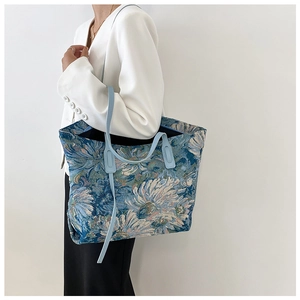Detail of large tote bag featuring vintage oil painting floral pattern and blue strap