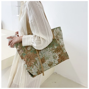 Detail of artistic oil painting daisy tote bag with durable leather straps and woven fabric