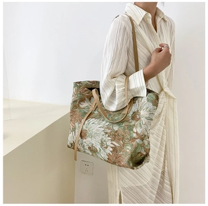 Detailed texture of vintage floral tapestry fabric on a large capacity tote bag