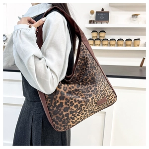 Detailed view of leopard print hobo tote bag worn as a shoulder bag in daily setting