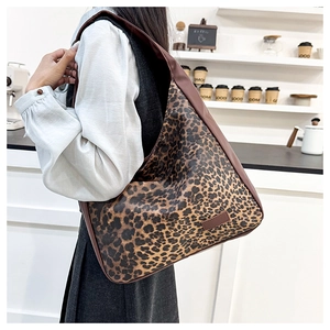 Detail of vintage leopard print tote bag featuring brown trims on white shirt model