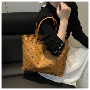 Close-up of brown tote bag with bear head patterns and durable double shoulder straps
