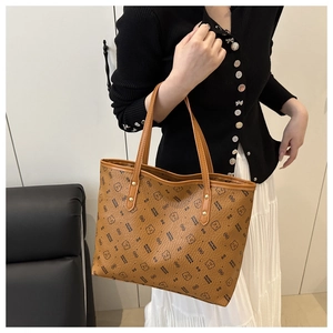 Detailed shot of brown tote bag with bear print and sturdy PU leather handles