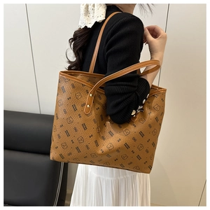 Detail view of large brown tote bag with cartoon bear pattern and twin shoulder straps