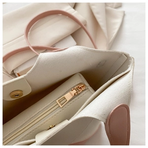 Gros plan sur le zip intérieur d'un sac seau en PU blanc et rose pour femme