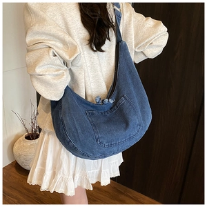 Large dark blue denim hobo bag with top zipper and spacious crescent shape design