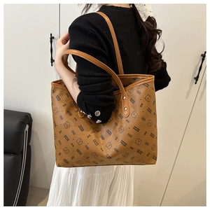 Detail of brown tote bag with bear print and brand letters on high-quality PU leather