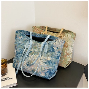Detailed view of jacquard floral tote bags with textured fabric and leather straps