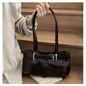 Detailed view of glossy dark brown retro leather underarm bag with silver buckle accent
