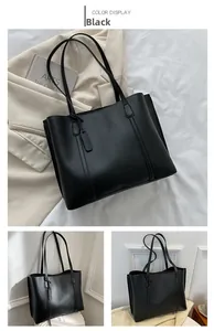 Detail view of large black PU leather tote bag with elegant hanging tag and slim shoulder straps