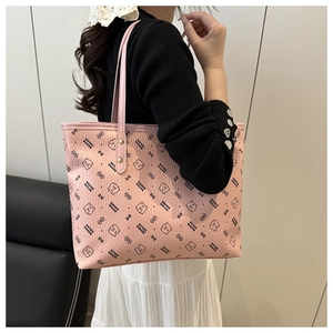 Detail of pink tote bag with bear print and litchi grain texture on model's shoulder
