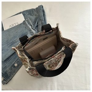 Close-up of floral jacquard tote bag showing interior capacity and zipper details