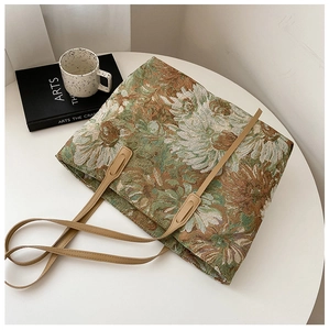 Detail of vintage floral jacquard tote bag with leather straps and daisy patterns