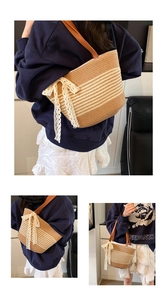 Close-up of woven straw tote bag with contrast stripes and elegant lace bow detail