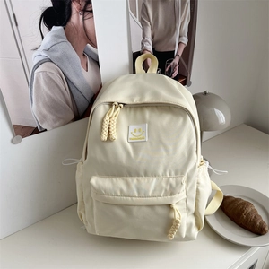 Sac à dos beige pour étudiante avec motif smiley jaune et grande poche avant