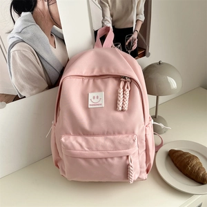Sac à dos d'école rose minimaliste avec écusson smiley et fermetures éclair tissées