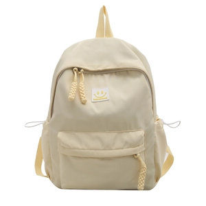 Minimalist beige high-capacity college backpack with a cute smile patch and yellow zip pulls