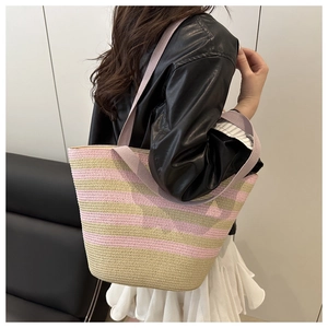 Detail of pink and beige striped woven straw tote bag with lavender shoulder straps