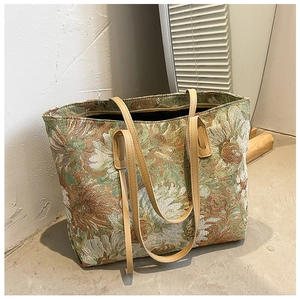 Close-up of vintage oil painting floral pattern on canvas tote bag with brown straps
