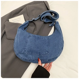 Detailed view of the blue denim hobo bag with adjustable strap and front pocket