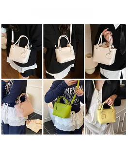 Detail view showing multi-way wear of the PU leather handbag with knot handle and charm