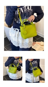 Detail of neon green PU leather handbag with cylindrical handle and smiley charm