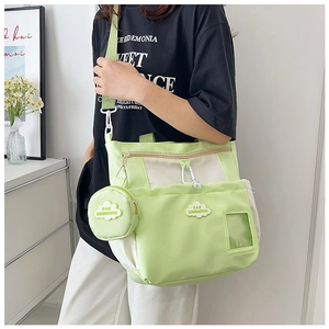 Close-up of light green nylon school bag with a detachable cloud-shaped coin purse