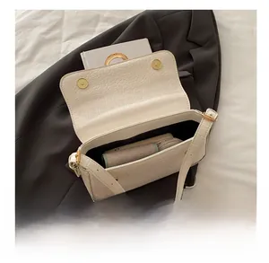Interior view of white crocodile pattern shoulder bag showing storage for small items