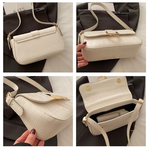 Detail view of white crocodile pattern PU baguette bag with gold buckle and inner space