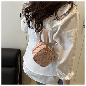 Detailed back view of a pink box bag with M-letter prints and gold chain strap