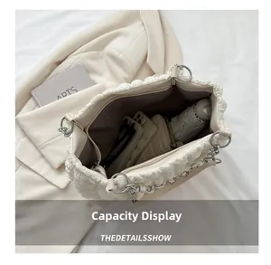 Detailed interior of a white bubble pleated tote bag showing large capacity for essentials