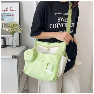 Detail of light green and white canvas tote bag with mini cloud charm pouch