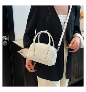 Détail du sac bowling blanc grainé avec finitions argentées et marquage élégant