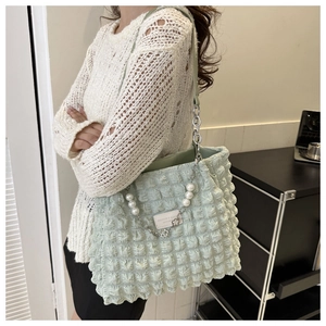 Light green bubble texture tote bag with pearl chain strap and leather label detail
