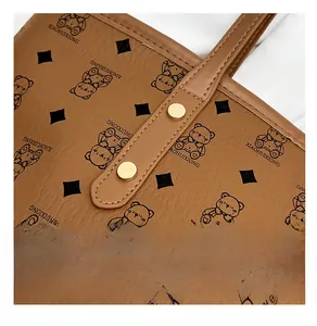 Detail of premium golden rivets on brown leather tote with vintage pattern