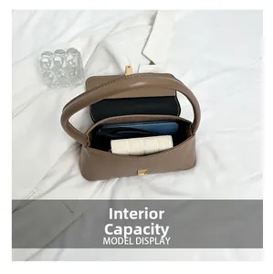 Macro view showing internal capacity for a smartphone and wallet in brown leather bag