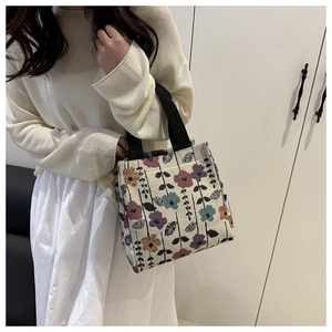 Detail of vintage oil painting floral jacquard canvas bag with black woven straps