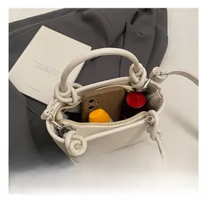 Internal view of litchi texture bucket bag showing space for phone and lipstick