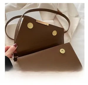 Close-up of golden magnetic metal clasp on brown leopard print leather handbag