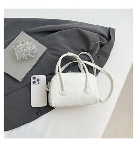 Detail view of white lychee grain mini handbag with fine texture and fashion printing